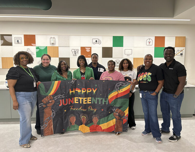 Littelfuse employees celebrating Juneteenth with a Happy Juneteenth banner